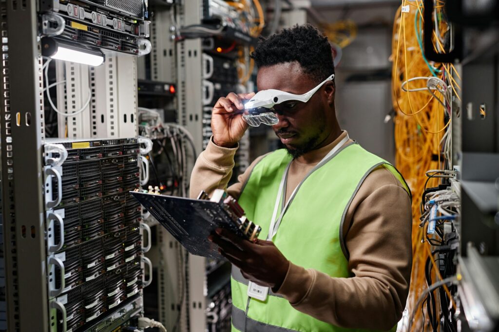 Technician inspecting and repairing server hardware in a data center