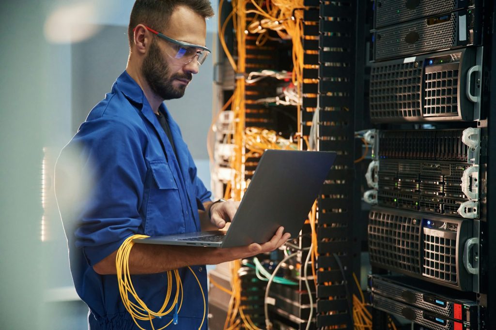Technician working with storage equipment in a server room