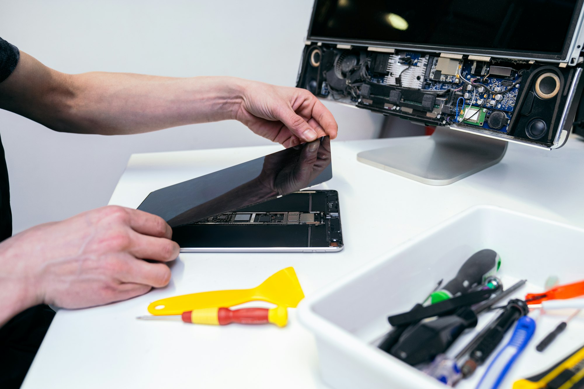 Technician repairing the screen of a consumer tablet