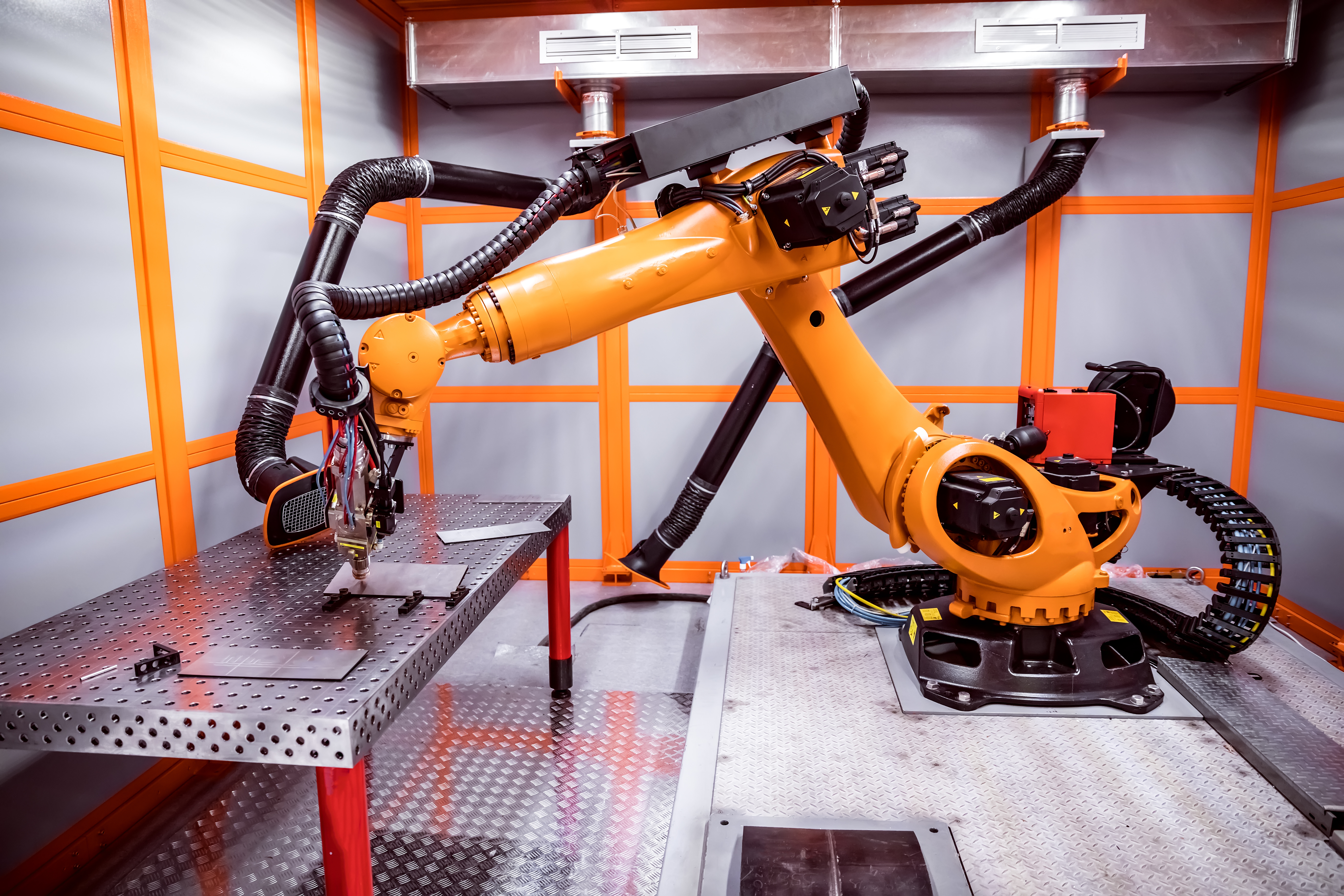 Robotic arm welding on an industrial manufacturing line