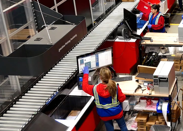 Warehouse worker scanning labels on packages for fulfillment