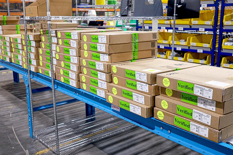 Verified and redeployment-labeled inventory staged on a warehouse flow rack